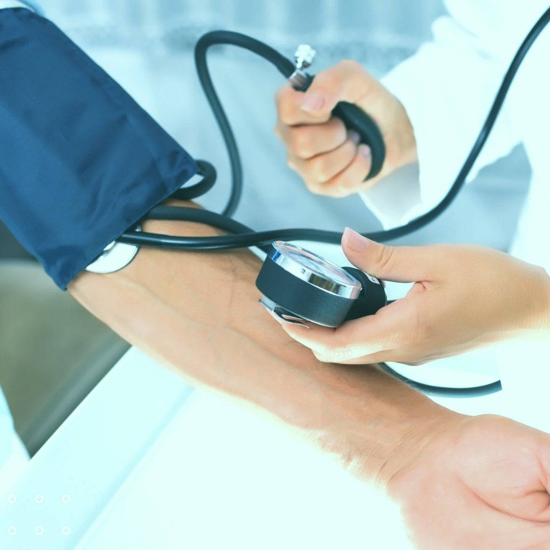 a person smiling while getting a gentle blood pressure check